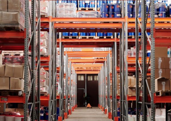 A modern warehouse interior showcasing organized shelves and pallets for efficient storage.